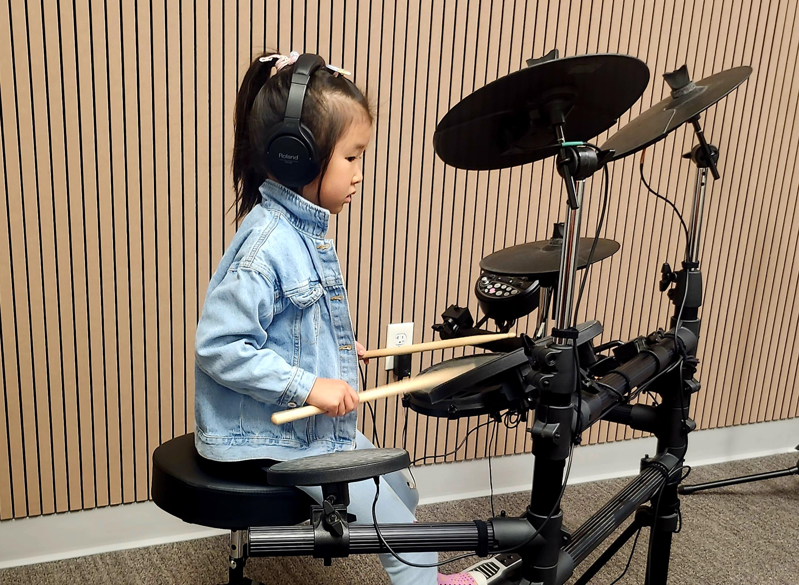 Playing drum set at our music studio